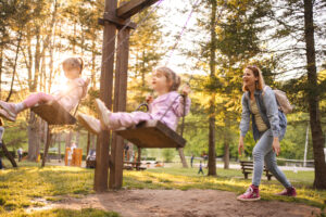 kids being pushed on swing