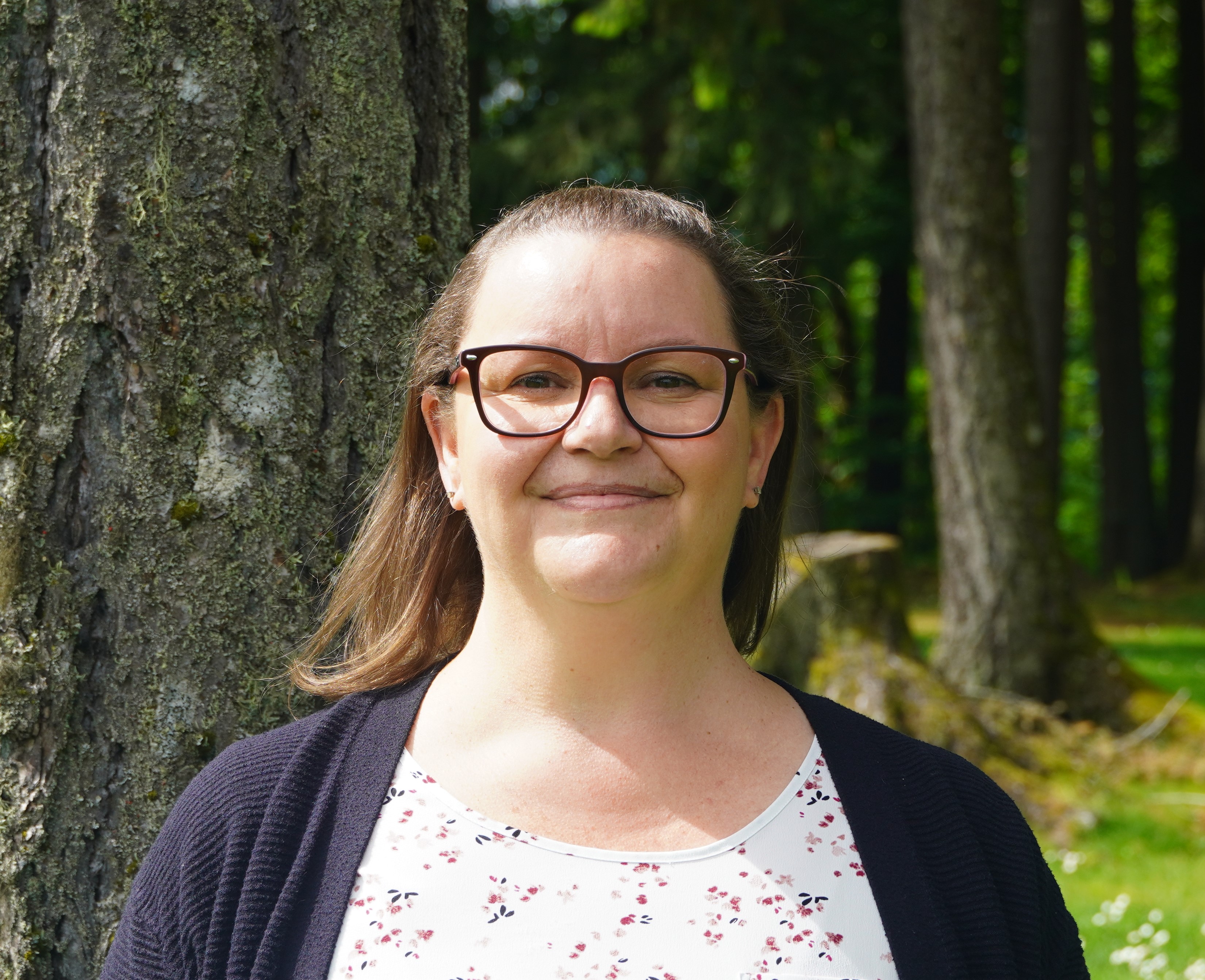 woman smiling in the woods