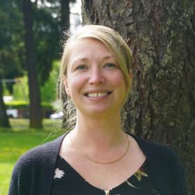 smiling woman in the woods